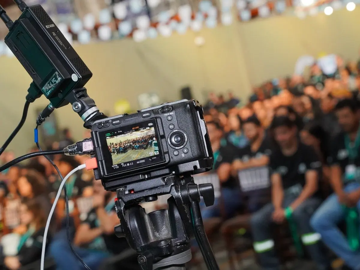 Câmera com transmissor sem fio captando a plateia de uma convenção de colaboradores